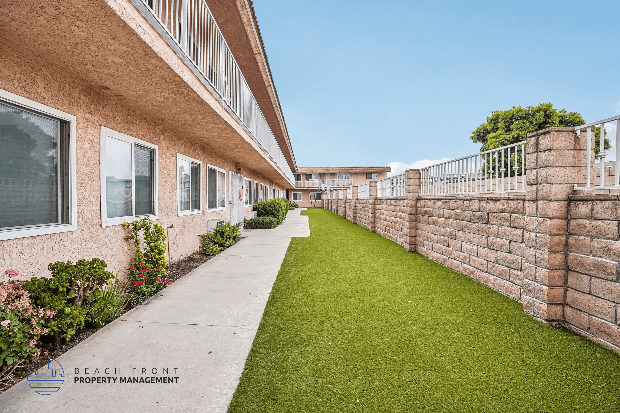 A long building with a lawn in front.